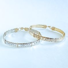 These personalized bracelets are made with .925 sterling silver and high quality 14kt gold-filled wire, making them perfect for everyday wear. With the ability to be personalized with names, dates, astrology signs, paw prints, or even a baby foot symbol, these bracelets can be custom-made to fit any occasion. Mothers and grandmothers love be able to sport children and grandchildren's names, and couples are able to easily fit both names and an anniversary date. Up to seven names generally fit( varies by size and length-of-name, please contact us for specific questions you may have). Sterling Silver Custom Name Bracelet For Anniversary, Personalized Gold Sterling Silver Bracelets, Personalized Sterling Silver Gold Bracelet, Anniversary Sterling Silver Bracelet With Custom Name, Personalized Gold Sterling Silver Name Bracelet, Customizable Gold Sterling Silver Bracelets, Customizable Gold Sterling Silver Bracelet, Custom Name Adjustable 14k Gold Jewelry, Classic Sterling Silver Custom Name Bracelet