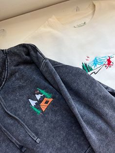 We sell primarily on our website where we offer  free shipping options. TwinRavenCo. See our website for a long-sleeve option as well.  This hoodie features a retro mountain camping vibe - perfect for any wintery adventure.  𓄿 Mineral Washed giving that perfect weathered look 𓄿 Unisex 𓄿 Split stitch double needle sewing on all seams 𓄿 Jersey lined hood 𓄿 1 x 1 ribbing at cuffs and waistband 𓄿 The embroidered design uses thread made from the highest quality, recycled materials 𓄿 Designed and embroidered in our studio in Canada * Check out our socials for discounts, new releases, and to see how we run our shop: TwinRavenCo Embroidery stabilizer is applied to the back of every embroidered item and is never to be removed. It is there to keep the stitches stable over time. This stabilize Outdoor Long Sleeve Cotton Hoodie, Cotton Hoodie For Outdoor, Outdoor Long Sleeve Cotton Sweatshirt, Cotton Long Sleeve Hoodie For Outdoor, Winter Hoodie With Embroidered Logo And Relaxed Fit, Long Sleeve Cotton Sweatshirt For Outdoor Activities, Cotton Long Sleeve Sweatshirt For Outdoor Activities, Hooded Cotton Tops With Embroidered Logo, Hooded Winter Sweatshirt With Embroidered Graphics