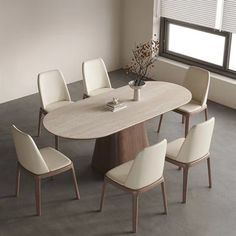 a dining table with chairs around it in front of a large window and windowsill