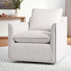 a white chair sitting on top of a rug