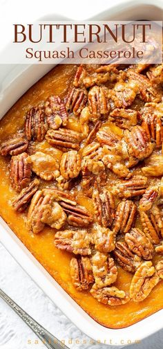 butternut squash casserole in a white dish with pecans on the side