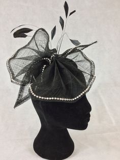 A very light and pretty headpiece with a loose bow shape made from a single layer of Sinamay on a circular black base. The entire edge of the bow is decorated with silver diamanté and there are a few black feathers for a bit of height and movement.  The solid base measures 13.5cms making it suitable for Royal Ascot.  It fixes to the head with elastic. Pastel Pink Dress, Cream Outfit, Hat Blocks, Hat Fascinator, Purple Hats, Wedding Fascinators, Royal Ascot, Black Feathers, Strong Colors