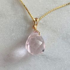 This is one of my classical pieces. I make this for my family and loved ones. And I wear one everyday. I designed this with a very delicate chain, so the rose Quartz looks as if it is just a sparkle floating on your skin. Rose Quartz is the stone of unconditional love, self love, universal love. Rose Quartz is the stone of universal love.  It restores trust and harmony in relationships, encouraging unconditional love. It purifies and opens the heart at all levels to promote love, self-love, frie Rose Gold Teardrop Jewelry With Delicate Chain, Delicate Rose Gold Teardrop Pendant Jewelry, Pink Teardrop Pendant Birthstone Jewelry, Pink Birthstone Teardrop Pendant Jewelry, Elegant Rose Quartz Faceted Necklace, Elegant Faceted Rose Quartz Necklace, Rose Gold Drop Jewelry With Delicate Chain, Feminine Pink Gold Jewelry For Gift, Dainty Rose Quartz Jewelry For Gifts