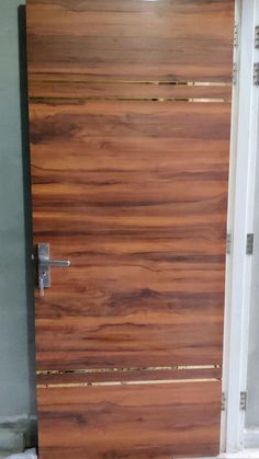 a close up of a wooden door with metal handles and bars on the bottom half