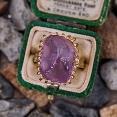 This stunning handmade vintage ring features a rectangular sugarloaf style amethyst cabochon in a twenty-six prong setting. The ring is crafted in a soft 14k yellow gold and is currently a size 7. Luxury Purple Amethyst Ring, Rectangular Shape, Luxury Purple Amethyst Rectangular Ring, Luxury Purple Rectangular Amethyst Ring, Art Deco Amethyst Ring In Yellow Gold, Classic Yellow Gold Rectangular Amethyst Ring, Yellow Gold Amethyst Ring In Art Deco Style, Rectangular Amethyst Ring In Yellow Gold, Art Deco Yellow Gold Amethyst Ring, Yellow Gold Amethyst Ring With Rectangular Shape