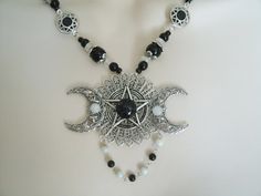 "This beautiful necklace has a black obsidian stone, moonstone settings, pewter silver pentacle, sterling silver plated triple moon pendant, moonstone beads, black obsidian beads, seed beads, pewter silver bead caps, pewter silver filigree connectors and metal chain. 18\" long. Sterling silver plated toggle clasp." Gothic Jewelry With Moon Charm, Black Moon Phase Necklaces For Festival, Black Moon Phase Necklace For Festival, Gothic Festival Jewelry With Moon Charm, Gothic Nickel-free Necklaces For Festivals, Gothic Adjustable Necklace With Moon Charm, Black Moon Charm Jewelry For Festivals, Gothic Silver Wire Wrapped Jewelry, Black Moon Phase Jewelry For Festivals