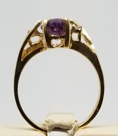 "We do not check prongs for wear or stones for looseness. All items are sold as is-noting that we are a resale shop so everything here had a previous owner! We will include flaws in the description when noted. This is one of the reasons our items are more affordable than new at a jewelry store. Vintage 10K Yellow Gold Ring with Amethyst & Diamonds, Size 5.75. Stamped 10KP inside band. Weighs 1.5 dwt. Please stop in often as we will be adding additional vintage fine jewelry beauties. Note tha Oval Amethyst Ring Stamped 14k, Purple 14k Stamped Collectible Jewelry, Purple 14k Stamped Ring, Collectible Yellow Gold Amethyst Ring, Gold Amethyst Ring With Center Stone, Collectible Amethyst Ring, Gold Amethyst Ring Stamped 14k, Gold Amethyst Ring With Hallmark, Gold Amethyst Ring With Accent Stones For Anniversary