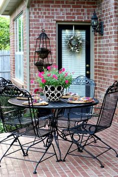 an outdoor table and chairs on a brick patio