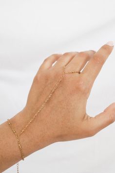 Get your hands on the perfect summer accessory - the Daisy Bead Hand Chain! Elevate your summer style with this unique hand chain that adds a touch of playfulness to any outfit. Perfect for those warm summer days, this hand chain is a must-have addition to your jewelry collection! Stack it with other dainty bracelets for a personalized touch! All of our jewelry comes with a free jewelry pouch and cloth to keep your pretties safe and clean. Details Color: PVD 18K Gold PlatedMaterial: Stainless St Adjustable Hand Set Chain Bracelet For Parties, Hand Chain Bracelet Gold, Double Daisy Chain Bracelet, Finger Bracelet Hand Chain, Daisy Chain Bracelet, Spiral Shell, 40th Gifts, Cuff Rings, Hand Chain