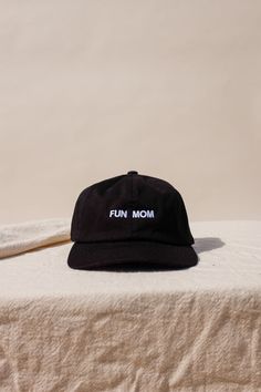 "Im not like a regular mom , I'm a fun mom." Intentionally Blank "Fun Mom" hat saying it all for you. cool mom One size. Adjustable back. Hand embroidered in LA. PIPE AND ROW Adjustable Curved Brim Fun Dad Hat, Fun Hats With Embroidered Logo One Size, Fun Hats With Embroidered Logo, Fun Embroidered Logo Hat One Size, Fun Embroidered Logo Baseball Cap, Fun Black Cotton Baseball Cap, Fun Baseball Cap With Embroidered Logo, Black Fun Snapback Hat With Curved Brim, Fun Dad Hat With Letter Print