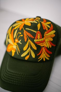 Tenango Hand Embroidered Trucker Hat- Olive Green - Gray Bird Label Adjustable Embroidered Trucker Baseball Cap, Adjustable Trucker Baseball Cap With Embroidery, Embroidered Summer Trucker Hat With Curved Bill, Embroidered Adjustable Trucker Hat, Spring Green Trucker Hat With Curved Bill, Trucker Baseball Cap With Embroidered Curved Brim, Green Curved Bill Trucker Hat For Spring, Green Trucker Hat For Festivals, Embroidered Trucker Baseball Cap