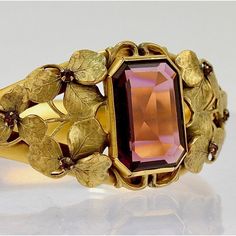 A very fine Victorian gold filled bangle bracelet.  Made by the W. & S. Blackinton Co. of Meriden, CT in the late 19th century.  The center is bezel set with an emerald-cut purple glass stone and surrounded with gold filled leaf work.    The veined leaves are bunched in groups, and each group itself has a very small purple glass stone set at its center.  It is engraved to the reverse with a period monogram MDC.  A wonderfully sophisticated Victorian era bracelet!  Date: Late 19th Century or Earl Antique Hallmarked Yellow Gold Cuff Bracelet, Antique Yellow Gold Hallmarked Cuff Bracelet, Antique Gold Antique Bracelet, Victorian Antique Gold Bracelet, Antique 14k Gold Bangle, Antique Cuff Bracelet For Formal Occasions, Antique Gold Bracelet In Antique Style, Elegant Antique Gold Bangle, Antique Gold Bangle For Formal Occasions