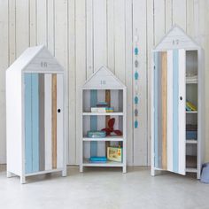 two white and blue children's bookshelves in the shape of little houses