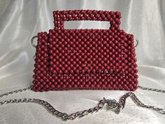 Handmade Dark Red Beaded Bag with Silver-Toned Hardware This elegant handbag, crafted from dark red beads, features silver-toned hardware and a 47-inch removable chain. The magnetic closure adds convenience and ease of use. Our bags are 100% handmade. Each bag is unique and crafted with love for our customers. It takes 3-5 days to create one bag. A perfect gift for women, friend, family member or loved one. Ideal for any celebration, event, wedding or birthday party. This unique and distinctive Red Beaded Rectangular Evening Bag, Elegant Red Beaded Bag, Elegant Red Beaded Shoulder Bag, Red Beaded Rectangular Shoulder Bag, Luxury Red Beaded Bag, Red Beaded Clutch Evening Bag, Elegant Handbag, Bead Bag, Red Beads