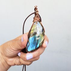 A beautiful colorful Labradorite wire wrapped with a sturdy tarnish free copper wire. This lovely pendant has a simple style wrap and the stone has some pretty tones of blue, green, yellow and purple. I wrap all of my jewelry with a sturdy tarnish free wire. Please view all of the photos for details and choose your chain length at checkout. All jewelry will come in a jewelry box or bag perfect to give as a gift. Need a personalized note? Let me know what you would like it to say. Buy more then o Wire Wrap Pendant, Purple Stones, Christmas Gift Jewelry, Labradorite Pendant, Gift Jewelry, Wire Wrapped Pendant, Jewelry For Women, Wire Wrap, Copper Wire