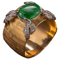 This 1950s-era band ring has been crafted by a master goldsmith. As with a fine Buccelatti jewel, every millimeter has been worked: from the freehand Florentine Finish to the gorgeously rendered four leaves -each set with 3 small white diamonds— and rendered in white gold. The jadeite stone measures 9.71 x 7.79mm and is a rich emerald green mottled with wisps of white clouds. The proportions on this ring are so balanced and authoritative; the jeweler who created this obviously created many, many Four Leaves, Jade Ring, White Clouds, Fine Jewels, White Diamonds, Cocktail Rings, Makers Mark, Band Ring, Diamond White