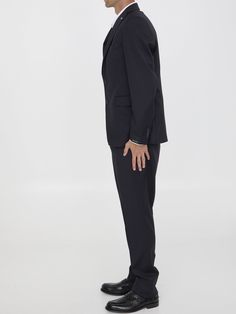 This two-piece suit is made of blue virgin wool with a hint of shine. It features a single-breasted jacket with peaked lapels and a brooch on the lapel, as well as a front button closure, two flap pockets, a chest welt pocket, and buttoned cuffs. The straight-leg pants have a zip and button closure, two side welt pockets, two rear buttoned welt pockets, and belt loops. Regular fit. The model is 189cm tall and wears size IT 50. Size nationality: IT Single breasted Peaked lapels Front closure Stra Wool Tuxedo Double Breasted Suit, Tuxedo Three-piece Suit With Lapel Collar, Classic Single Breasted Formal Pantsuit, Single Button Suit With Suit Collar, Classic Single-breasted Formal Pantsuit, Formal Single Breasted Pantsuit, Tuxedo Suit With Lapel Collar For Office, Tuxedo Suit With Suit Collar For Work, Double Breasted Suit With Single Button For Workwear