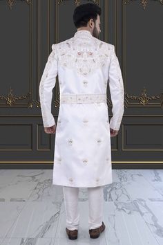 Introducing the V20-S45 Mens Sherwani, adorned with intricate peacock and elephant embroidery. This stunning white sherwani is accented with rich red details. Perfect for grooms seeking luxurious elegance on their special day. Elevate your style with this exclusive piece. Traditional White Kurta With Naqshi Drape, White Kurta With Naqshi And Traditional Drape, White Kurta With Naqshi In Traditional Drape, White Resham Embroidered Fitted Nehru Jacket, Elegant Churidar For Eid And Traditional Ceremonies, White Resham Embroidery Nehru Jacket, White Fitted Nehru Jacket For Transitional Season, Elegant Kurta With Traditional Drape For Ceremonies, White Traditional Wear With Naqshi