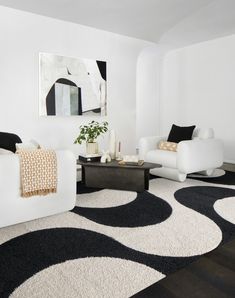 a living room with black and white decor