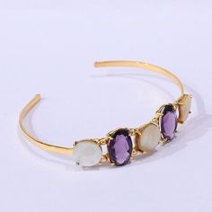 "Mother Of Pearl Bangle, Faceted Stone Bangle, Amethyst Bangle, Prong Set Bangle, Adjustable Bangle, Best Gift For Women  Product Details Item Code: BJBC-1504 Stone Name: Amethyst, Mother Of Pearl Stone Shape : Oval, Round Stone Size : 11mm, 10*16mm Metal: 18K Yellow Gold Plated Over Brass Bracelet Inner diameter: 2.50\" Inch Note: The bangles you will receive may vary slightly in color from the images because these are natural gemstones that vary from each other every single time, and it is not possible to get the same color as what is shown in the images. Images are for reference to get an idea of a similar color you will get. Shipping Info: All my items are safely and nicely packaged and shipped in a beautiful plastic box with bubble wrap. The package is sent via international registere Purple Bangle Bracelet With Natural Stones, Amethyst Natural Stone Bangle Bracelet, Gold-plated Gemstone Bangle, Luxury Elegant Amethyst Bangle, Adjustable Amethyst Bangle, Amethyst Bangle, Brass Bangle, Pearl Bangle, Stone Bangle