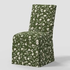 an upholstered chair with floral print on the back and seat, in dark green