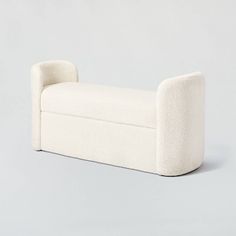 a white couch sitting on top of a gray floor