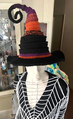 a woman wearing a hat made out of crocheted yarns and spider web