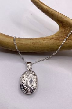 "Vintage Silver Locket Necklace  The Tiny Oval Photo Locket measures about 1/2 inch long (without the bale), features a lovely etched design and is the perfect necklace for a small photo or other memory  Paired with a delicate 925 Sterling Silver Chain available in lengths of 16, 18 ,20, 22\" or 24\" We recommend using a laminated photo for longevity  Thank you for supporting a small veteran owned business! All jewelry is shipped free within the US in a stylish gift box" Silver Engraved Oval Link Necklaces, Sterling Silver Oval Link Jewelry Stamped 925, Silver Engraved Oval Link Necklace, Silver Oval Link Engraved Necklace, Engraved Antique Silver Oval Necklace, Sterling Silver Locket Necklace With Oval Link, Sterling Silver Oval Link Locket Necklace, Silver Sterling Silver Locket Necklace With Oval Link, Silver Stamped Oval Pendant Jewelry