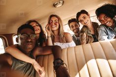 a group of young people sitting in the back of a car with their arms around each other