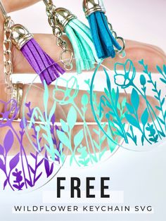 three key chains with different colored tassels on them and the text free wildflower keychain svg