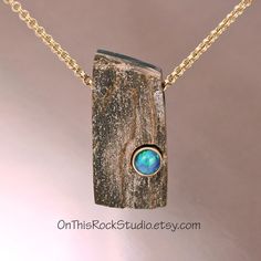 This is a special piece of petrified wood.  It has a fine, delicate quartz druzy surface that glistens in light.  This is completly natural.  The wood is laminated to a piece of black onyx on the back.  And into the front of the petrified is an Australian blue/green opal.  The opal is bezel-set in 14k gold.  These stones are completely natural.  I just put them together. This piece is not large; it measures 1-1/8 inch in height, and a little over 1/2 inch in width, making it a perfect size for f Natural Rock Jewelry, Wood And Stone Jewelry, Silver And Stone Jewelry, Petrified Wood Jewelry, Stone Settings Jewelry, Wood Jewelry Diy, Lapidary Jewelry, Wood Jewelery, Wire Wrapped Stone Jewelry