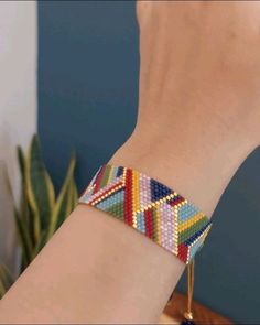 a person wearing a colorful bracelet on their wrist