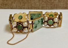 "Welcome To Gold Knox Beautiful vintage 14K solid yellow gold and green jadeite jade bracelet. 18K gold slide clasp with safety lock. Details Below: Material 18K Yellow Gold, Green Jade, white pearl Hallmark 18K, MR Length 7.25\" long Width 13.8 mm wide Jade 13 mm X 19 mm Cabochon Jade 5 mm Pearl 5 mm This would be a great gift on any occasion. Thank you for looking Gold Knox opened its storefront in Pasadena, CA in 2011, since then we have an online store on eBay, and we joined Etsy in 2016 whe Heirloom Jade Jewelry For Formal Occasions, Formal Yellow Gold Jade Bracelets, Formal Yellow Gold Jade Bracelet, Formal Rectangular Jade Jewelry, Collectible Yellow Gold Jade Jewelry, Jade Bracelet For Wedding, Elegant Gold Jade Bracelets, Elegant Yellow Gold Jade Bracelets, Elegant Yellow Gold Jade Bracelet