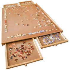 three wooden trays with puzzle pieces on them