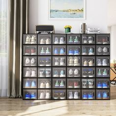 a large display case filled with lots of shoes next to a painting on the wall