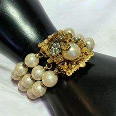 Gorgeous DE MARIO Vintage Signed Bracelet. Made in the 1940s-1950s with Faux Pearls, Gold Plated Metal, Crystal  Rhinestones and a gorgeous Floral Metal Filigree Beadwork design for the focal point of the bracelet complimented by the pearls. The intertwined seed pearls with leaves is just stunning. The craftsmanship does not go unnoticed in his pieces.  Measures - 8" inches "Robert De Mario (Est. 1945 - 1965) Sources disagree about whether Robert De Mario began his jewelry design career in the 1940s working for assorted New York City designers or specifically with Miriam Haskell. This could be because De Mario's work is occasionally confused Haskell's as there is a similarity in the intricacy of both designers' beadwork and pearl designs. There is, however, no disagreement that De Mario op Victorian Jeweled Wedding Bracelets, Vintage Charm Bracelets For Wedding, Vintage Adjustable Bracelets For Wedding, Adjustable Vintage Bracelet For Wedding, Adjustable Vintage Bracelets For Wedding, Elegant Wedding Bracelets With Vintage Charm, Vintage Jeweled Bracelets For Wedding, Vintage Pearl Bracelet For Anniversary, Vintage Beaded Wedding Bracelets