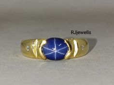 a gold ring with a blue stone in the middle