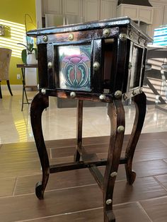 an ornate wooden table with glass in the middle