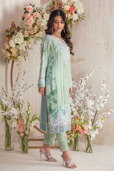 Stylish and trendy this cotton net ensemble is a must have this Eid season, light breezy hue with color blocked back & tie n dye details, featuring anchor thread embroidery further enhance with sequins, beads and pearls and pop of mint and powder blue silk thread florals to accentuate the entire look, paired with lace and pin-tuck detailed pant and hand block printed dupatta with lace details. Shirt Fabric: Cotton Net Shirt Length: 42” Pant Fabric: Khaadi Silk Dupatta Fabric: Organza Net Shirt C Cotton Silk Straight Kurta Set For Spring, Green Bohemian Cotton Silk Sets, Bohemian Dabka Work Sets For Spring, Summer Cotton Silk Sets With Floral Embroidery, Spring Cotton Silk Sets With Embroidery, Spring Embroidered Cotton Silk Set, Embellished Georgette Kurta For Summer, Embellished Straight Kurta For Summer, Spring Blue Georgette Kurta