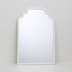 a white mirror sitting on top of a table