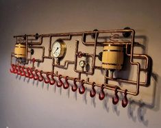 there is a wall with some pipes on it and a clock hanging from the side