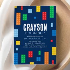 a blue birthday party card with lego blocks on it and the words, grayson is turning 6