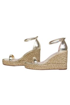 Upgrade your shoe closet with these stylish shimmering espadrilles! Made in a glimmering gold hue with a single strap across the toe. This comfy and stylish shoe will be sure to add a bit of glamour to your jeans and T-shirt combo! Size 9.5 Made in Spain Open toe Ankle strap Dust bag and box included Heel height 4.5" Chic Metallic Sandals For Spring, Gold Wedge Sandals With Wrapped Heel For Evening, Gold Closed Toe Heels For Spring, Elegant Gold Wedge Sandals With Wrapped Heel, Gold Sandals With Wrapped Wedge Heel, Chic Metallic Sandals For Summer, Metallic Spring Heels, Elegant Gold Open Heel Wedge Sandals, Elegant Open Toe Espadrilles For Spring