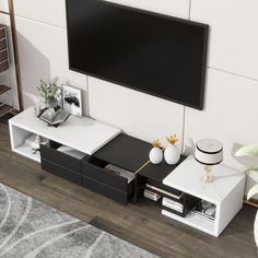 a flat screen tv mounted to the side of a wall next to a coffee table