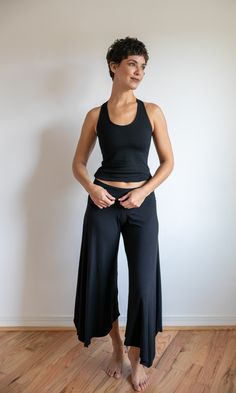 These pants are super flattering and fun to wear because of the gracefully flared leg. The fold-over waistband flattens the tummy, giving it a smooth look. Perfect for dressing up or casual wear. At the office, at the beach, yoga, and dancing. Made from a deliciously soft fabric with wonderful stretch and holds its shape well. This fabric is a very high-quality rayon lycra blend. Shown here in Black, paired with the Faith Strappy Woven Back Tank in Black. The Paris Flared Leg Pants are also available in Burgundy, Mocha, and Dark Teal. Great attention to detail when creating each item guarantees long-lasting wear. When properly cared for, these clothes remain beautiful year after year. Machine or hand wash cold delicate. Hang to dry. Black Flare Loungewear Pants, Black Wide Leg Elastane Yoga Pants, Black Flare Bottoms For Loungewear, Black Wide Leg 4-way Stretch Yoga Pants, Chic Wide-leg Yoga Pants, Black Wide Leg Yoga Pants With 4-way Stretch, Summer Wide Leg Elastane Pants, Flared Yoga Bottoms In Solid Color, Stretch Flare Wide Leg Pants