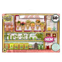 an assortment of plants and flowers in a display case with price tags on the front