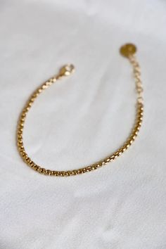 The Holland Chain Bracelet is made with 24 karat gold plate and features a round box chain for a classic yet luxurious look. With its sleek design and top quality materials, this bracelet is perfect for special occasions or everyday wear. Materials: 24kt gold plate brass Length: 6.5"+ 1.5" extender Handmade in Utah by Katie Waltman Jewelry Classic Gold Jubilee Bracelet In Brass, Classic Brass Gold Jubilee Bracelet, Classic Gold Bracelet With Adjustable Chain, Classic Gold Chain Bracelet With Rolo Chain, Classic Gold-tone Box Chain Bracelets, Elegant Gold Bracelets With Rolo Chain, Classic Gold Bracelets With Rolo Chain, Brass Gold Bracelet As A Gift, Gold Chain Brass Bracelet Gift