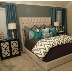 a bedroom with blue and gray decor in it