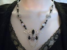 "This beautiful necklace has a black faceted glass setting on a sterling silver plated filigree pendant, a pewter silver pentacle, czech glass beads, seed beads, pewter silver bead caps, pewter silver filigree accents, black crystal drops and metal chain. 18\" long. Toggle clasp." Gothic Silver Necklaces For Festival, Gothic Sterling Silver Necklace, Gothic Silver Jewelry For Festival, Gothic Silver Festival Jewelry, Silver Gothic Jewelry For Jewelry Making, Gothic Wire Wrapped Pendant Jewelry, Gothic Nickel-free Jewelry For Festivals, Gothic Nickel-free Necklaces For Festivals, Gothic Silver Necklaces Nickel-free