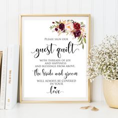 a framed print with the words guest guilt and flowers on it next to some books